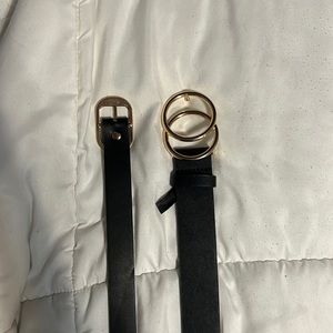 Two black belts with gold details
